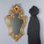 Carved and gilded wood mirror made in Italy in the mid-20th century. The molded frame is enriched with floral and leaf...