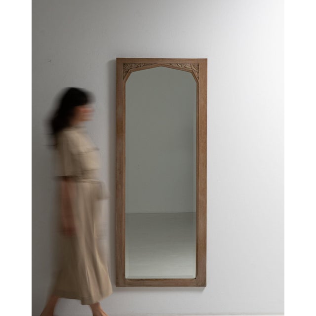 This mirror makes its impression through natural honey oak frame, arched top. Dating to 1910s and originating from France,...