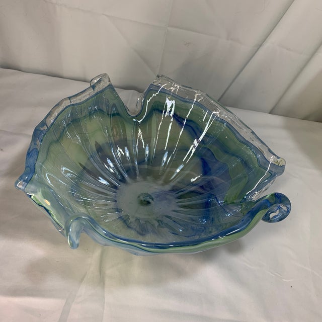 This appears to be a vintage hand-blown Murano-style art glass decorative bowl featuring a fluted rim and blue, green, and...