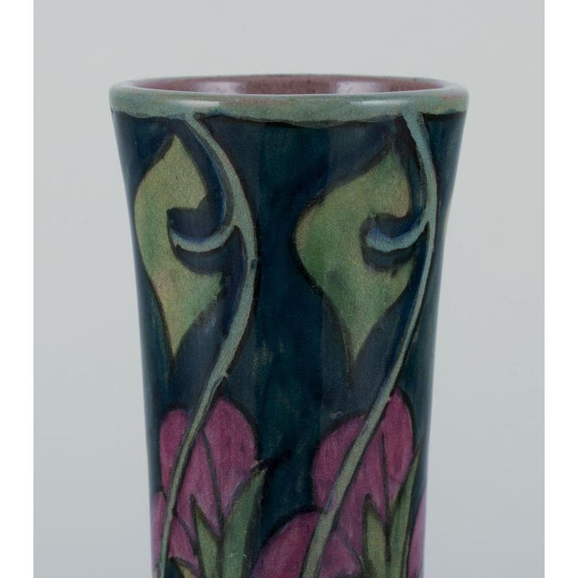 Zuid-Holland, Gouda. Unique Art Nouveau vase in glazed ceramic with hand-painted floral motifs. Polychrome glaze. Slim...