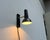 Simple wall light by Hustadt Leuchten. The light head has a simple spotlight shape and can be adjusted via a joint. The...