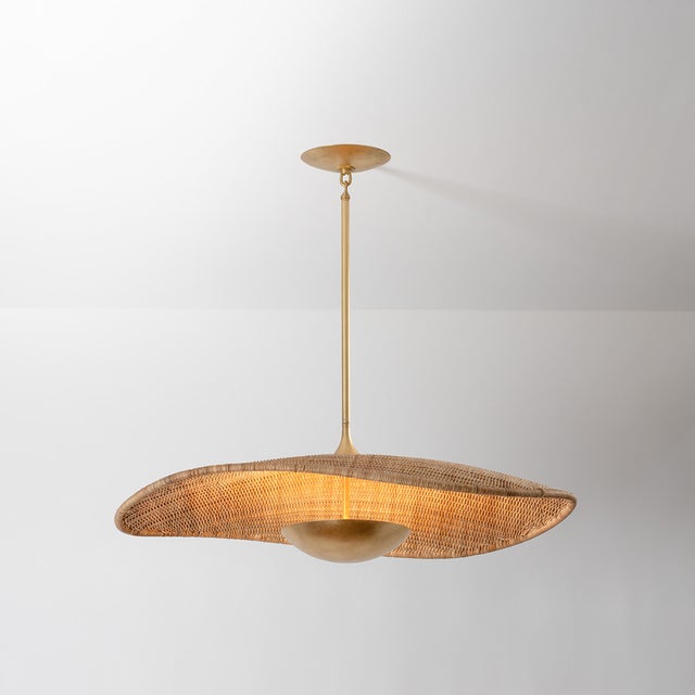 A dialogue between form and material, this nature-inspired design undulates with charm. The interplay of woven rattan and...