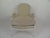 Louis XVI style bergere with white painted wood and nickel nail heads. Upholstered in leather. Seat cushion upholstered in...