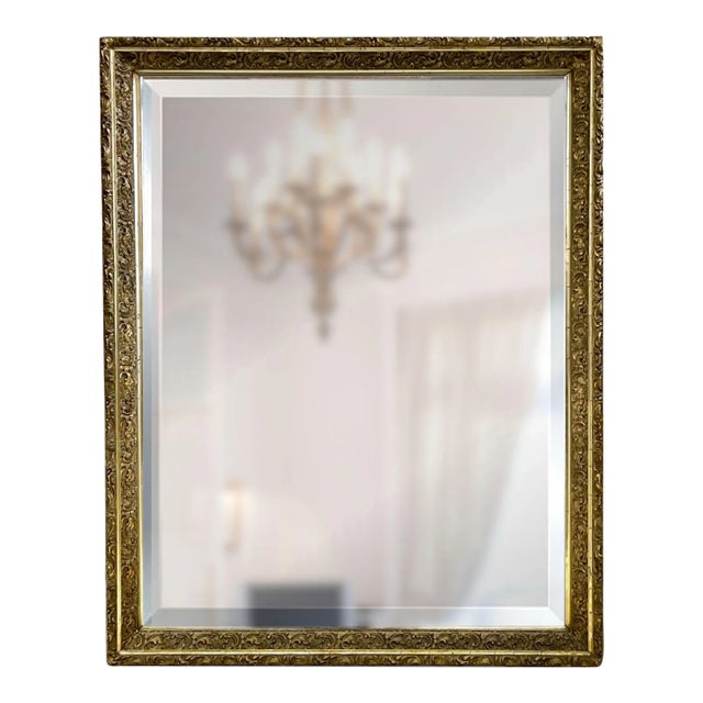 An absolutely stunning antique French mirror, grand in both scale and style. This beautifully carved piece features a...
