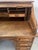 American-style solid oak desk Two four-drawer pedestals S-shaped roll-top top Interior compartmentalized with drawers and...
