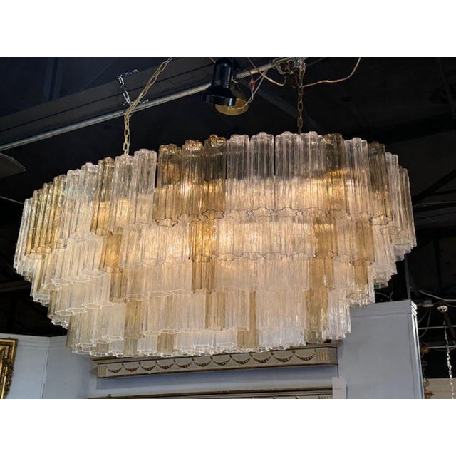 Modern Murano "tronchi" oval chandelier in 2-tone clear and fume. Circa 2000. The chandelier has been professionally...