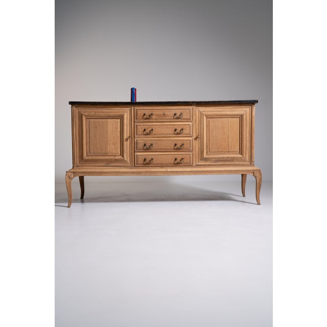 Rendered in richly grained French oak, this distinguished sideboard evokes the graceful sensibility of the Louis XV period...