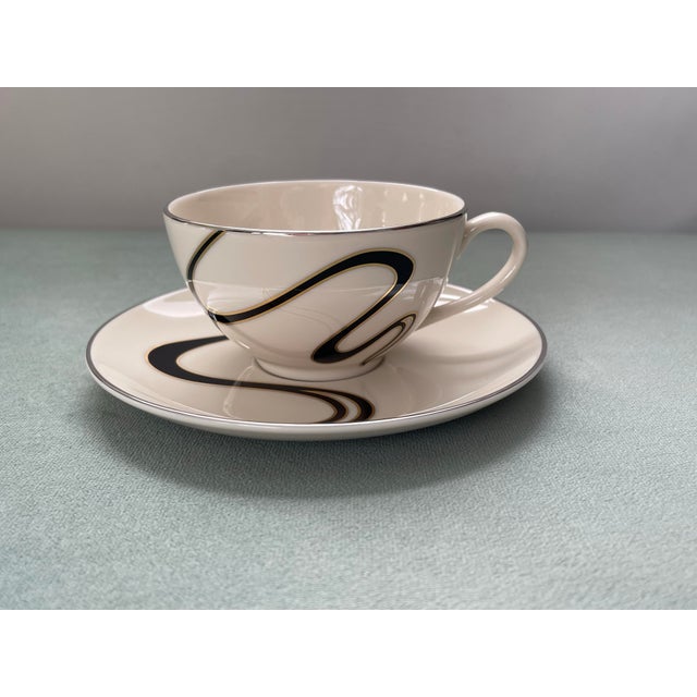 A charming abstract tea cup & saucer with metallic details in very good condition with light wear from use. -Saucers...