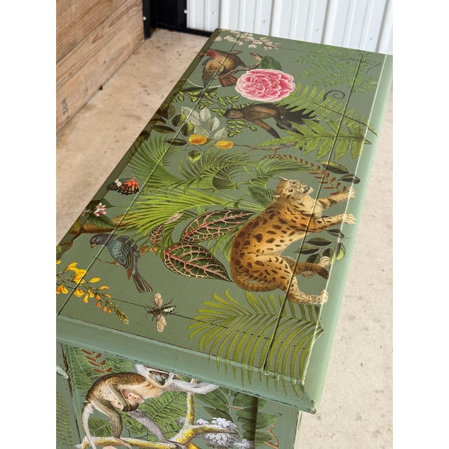 A true statement piece for the wild-at-heart. This antique cabinet has been transformed into a lush botanical dreamscape...