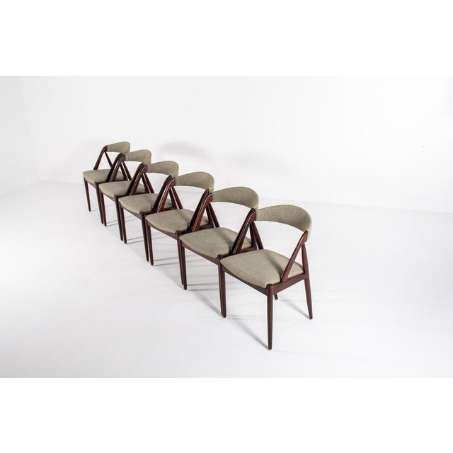 A rare and elegant set of six original Model 31 dining chairs designed by Kai Kristiansen in the 1960s. Crafted from rich...