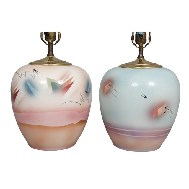 A pair of hand painted Postmodern table lamps by ceramic artist Judith Stiles of New York, NY. Vases are topped with brass...