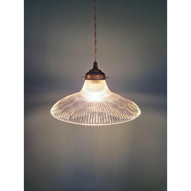 Art Deco pendant light in clear, fluted glass, 1930s. The pendant has been restored and rewired; it is compatible with an...