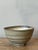 This serene and deeply textured studio pottery bowl captures the essence of classic Mid-Century ceramic art, emphasizing...