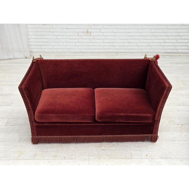 1970s, Danish 2-seater drop arm "Spanish" sofa. Original red/burgundy furniture velour, ash wood legs, springs in the seat...