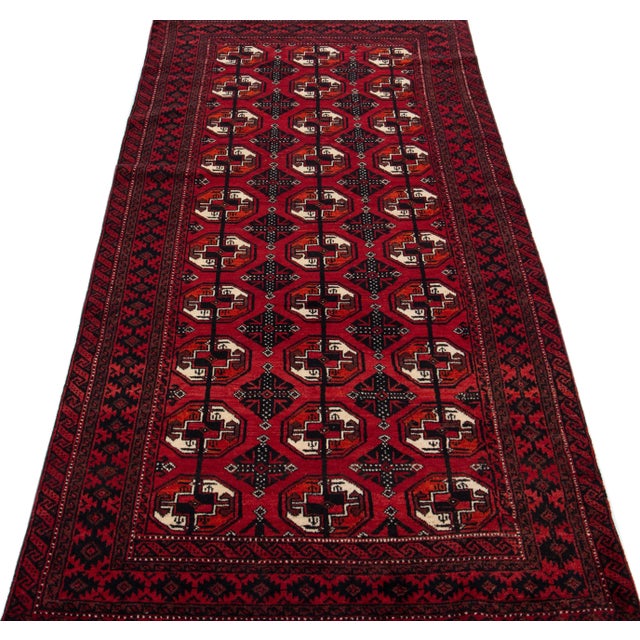Beautiful antique Turkmen hand-knotted wool rug with a red color field. This Persian piece has a gorgeous Gul pattern...