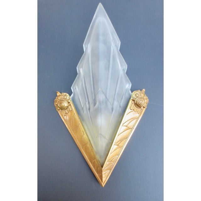 Degue Frosted glass Art Deco shades in high-style gilt bronze mounts. Classic Deco graphic angular patterns ending in...