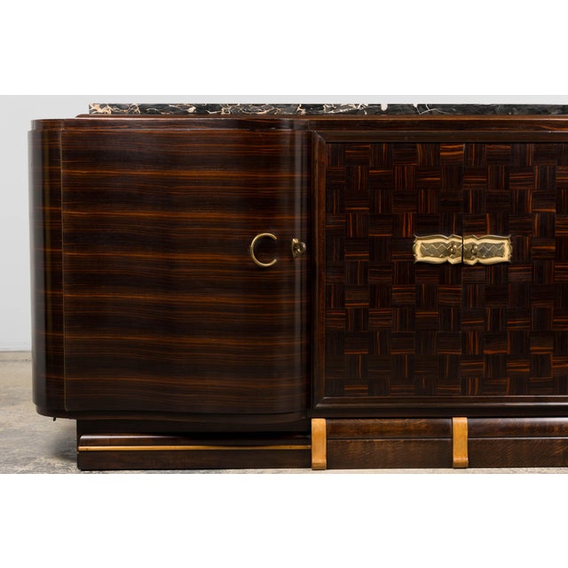 An exquisite 1940s Art Deco sideboard sourced in Paris, France, exemplifying the refined craftsmanship and elegant...