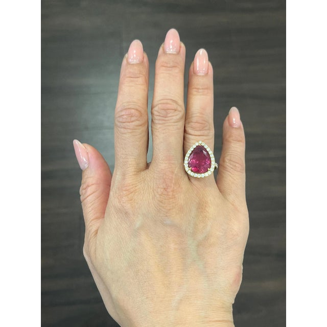 This beautiful natural rubellite ring weighs 7.75 ct. It has a striking 6.90 ct rubellite teardrop gem and 38 diamonds...