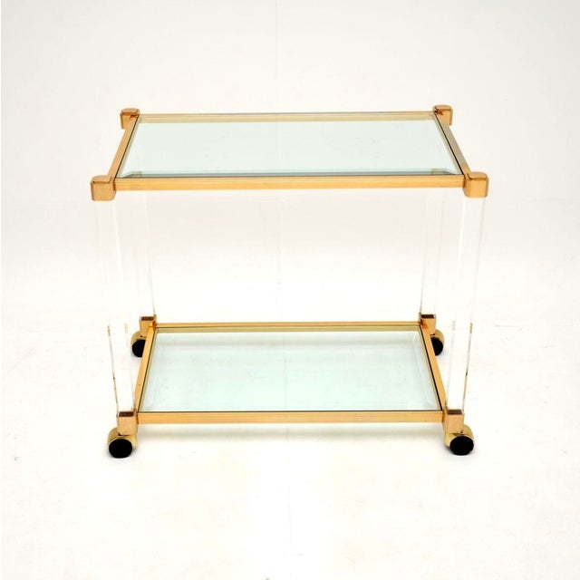 A stylish and extremely well made vintage French acrylic glass and gold plated drinks trolley, dating from the 1970’s. The...