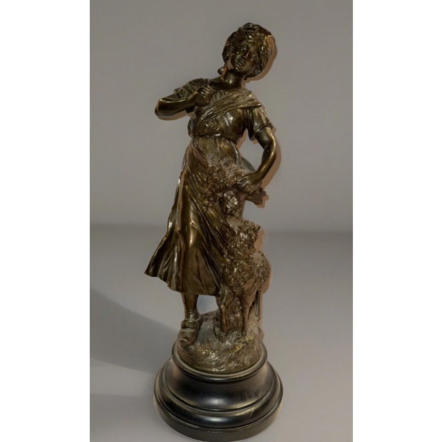 This listing is for a French Art Nouveau sculpture depicting a girl with a lamb. It is made from plaster and is signed “F....