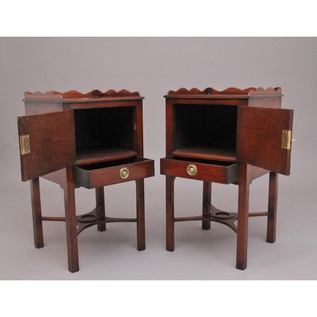 A nice decorative pair of early 20th Century mahogany bedside cupboards, lovely figured tops having a three quarter shaped...
