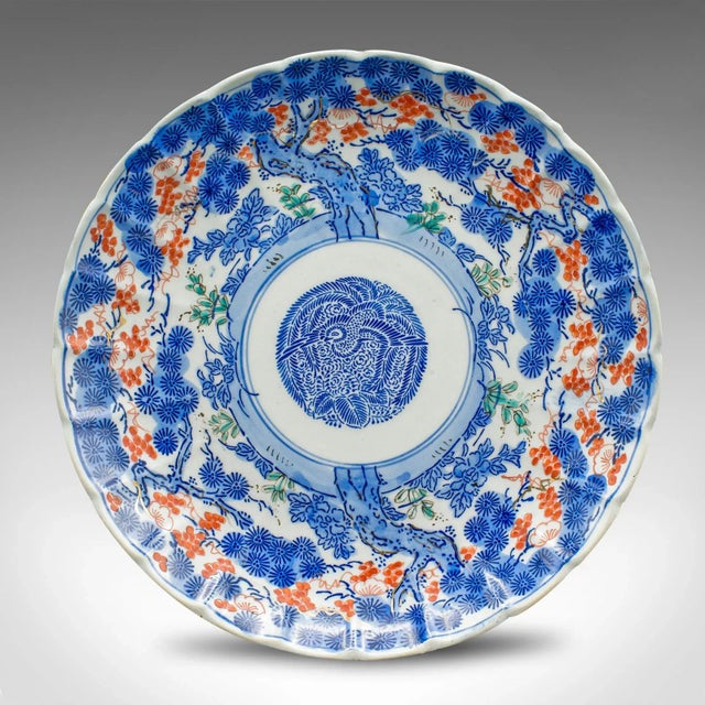 This is an antique decorative plate. A Japanese, ceramic serving dish with blue Imari taste, dating to the late Victorian...
