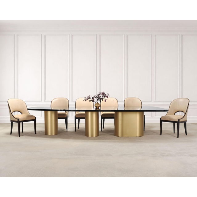 A monumental and rare signed sectional dining table constructed from brass and lacquered walnut designed by India Mahdavi...