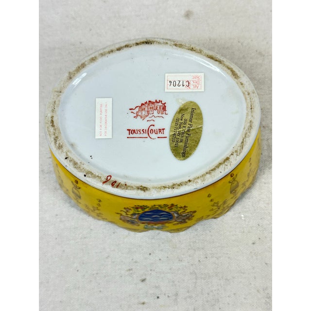 Vintage French cachepot by ToussiCourt with scalloped edge decorated with a coat of arms design. This is a pre-owned item...