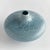 A narrow opening, reactive glaze and highly textured organic dot pattern, this decorative vase is a true work of art. A...
