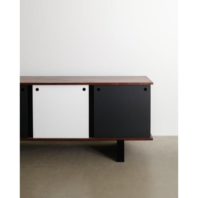 A very rare french mid century "bloc" sideboard cabinet in black lacquered metal, dark stained veenered mahogony wooden...