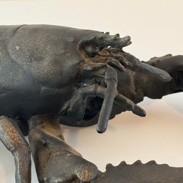 Meet Leo—a striking vintage cast-metal lobster sculpture with a dark blackened finish and beautifully aged metallic...