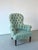 Vintage Victorian-style armchair with a high button-tufted backrest and elegant scroll arms. Upholstered in washed blue-...