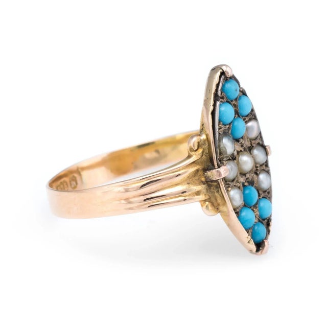 Finely detailed antique Victorian ring (circa 1896), crafted in 15 karat yellow gold. 8 x 2mm seed pearls are accented...