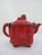 Chinese red lacquer molded teapot, inspired by Ming Dynasty designs. Striking red tone lacquer. Footed teapot with lid and...