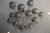 The Donghia Renaldo 18-Arm Chandelier features a luxurious design with grey glass globes and a polished chrome finish,...