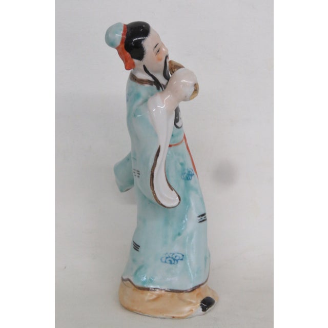 This lovely Fu Xing Figurine is made out of ceramic. This lovely figurine is a very charming depiction of the traditional...