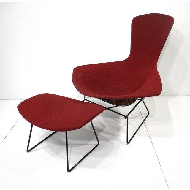 A sculptural vintage Bird Chair and matching ottoman in it's original reddish maroon toned woven fabric wrapped around a...