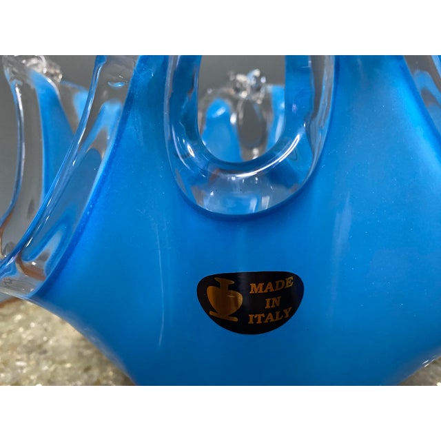 This blue Murano glass vase has a gorgeous clear filigree around the top of the vase. This is a beautiful piece that...