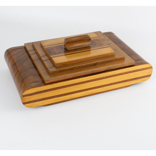 This stunning Art Deco geometric lidded box was expertly crafted in France, circa 1930. The rectangular shape features a...