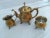 This lovely petite three-piece set is a fantastic example of a very traditional shaped English brass plated tea set. The...