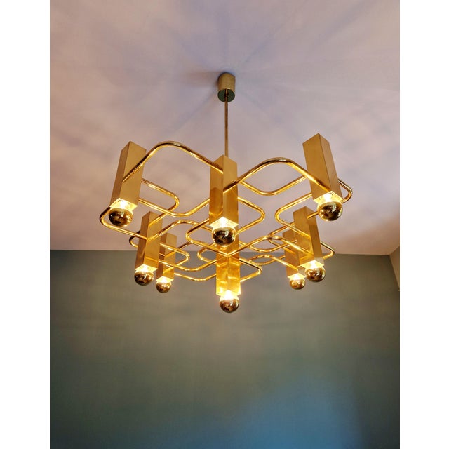 Large brass chandelier, designed by gaetano sciolari for the belgian manufacturer boulanger, 1970s. this geometric...