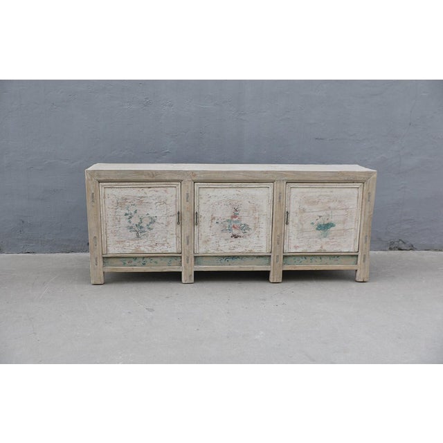 Antique Chinese Painted Elm Cabinet, from Shandong province, late Qing Dynasty. Originally a top opening rice chest, it...