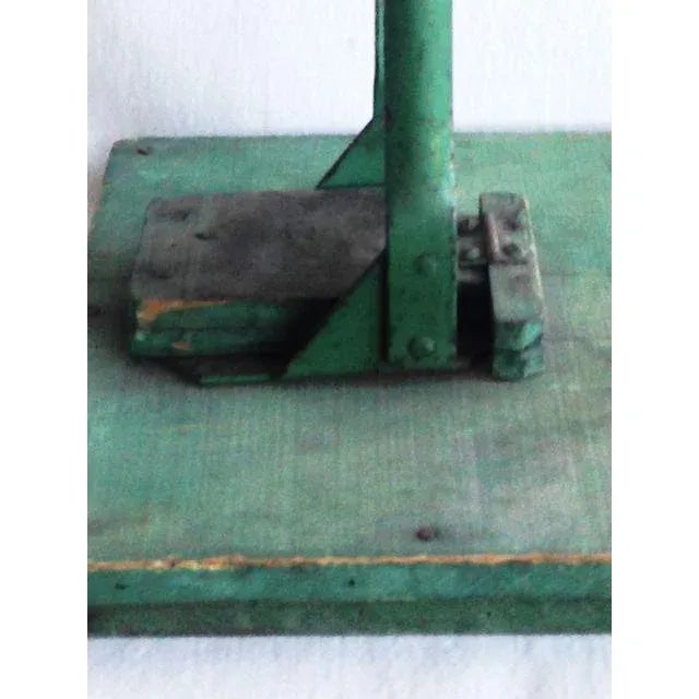 A vintage folk art wooden bottle capper with old paint. Rustic Americana.