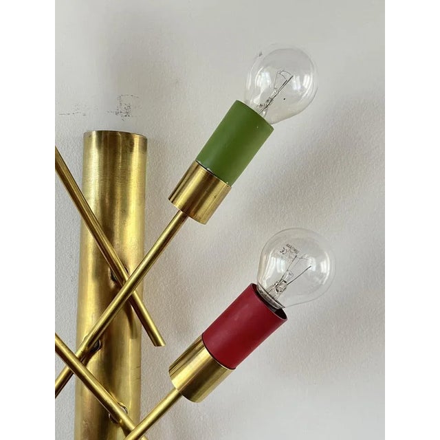 Rare couple wall lamps in brass, 1950s at 4 lights, Italian production. Base concave, each has four inclined rods which,...