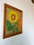 A vibrant and richly textured 1970s vintage still life painting depicting bold sunflowers and foliage, rendered in thick...