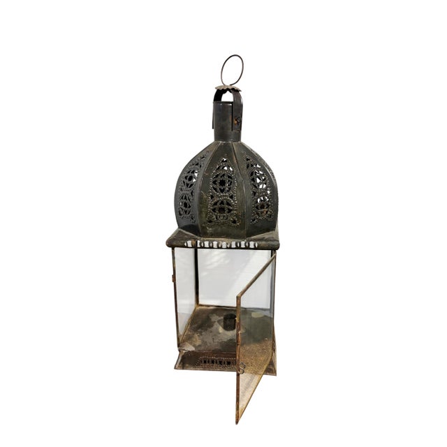 Vintage Moroccan lamp featuring an intricately hand-hammered dome with hanging fixture. Glass panels frame the sides,...