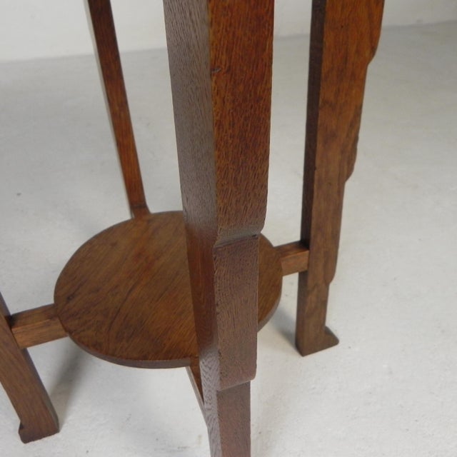 Discover the enchantment of the 1930s with this unique Amsterdam School table! The brass top is richly decorated with...