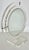 Sleek and timeless lucite vanity mirror. Circa 1980. Light pitting on metal details. Some small age spot along mirror...