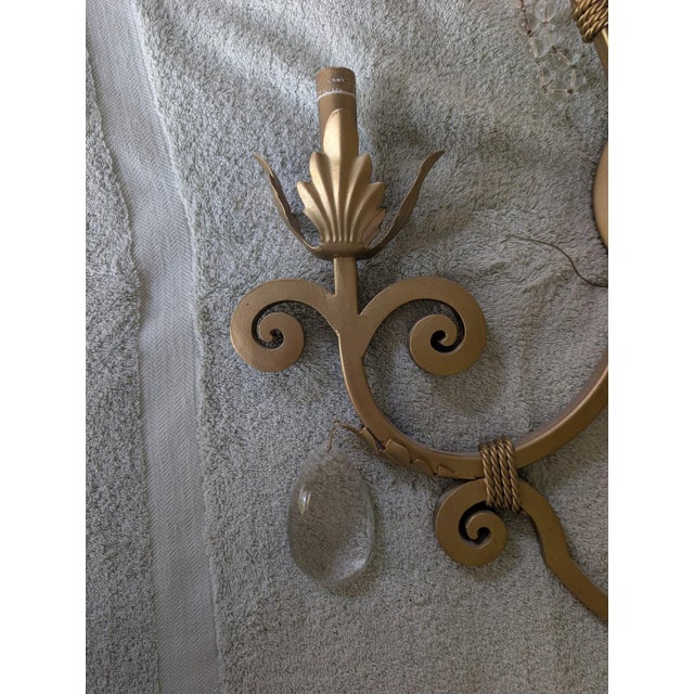 Elegant pair of Kalco 2-light wall sconces featuring a warm champagne, gold finish, scrolling, ironwork, crystal bead,...