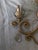 Elegant pair of Kalco 2-light wall sconces featuring a warm champagne, gold finish, scrolling, ironwork, crystal bead,...